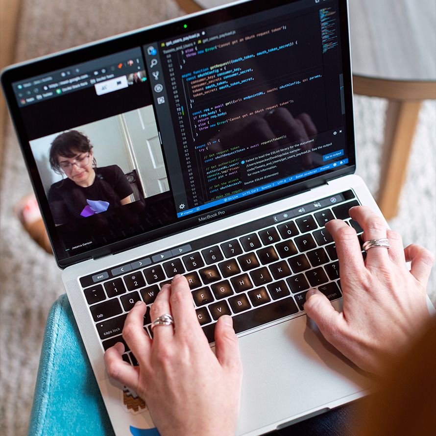 person typing on a laptop while having a conference in the split window